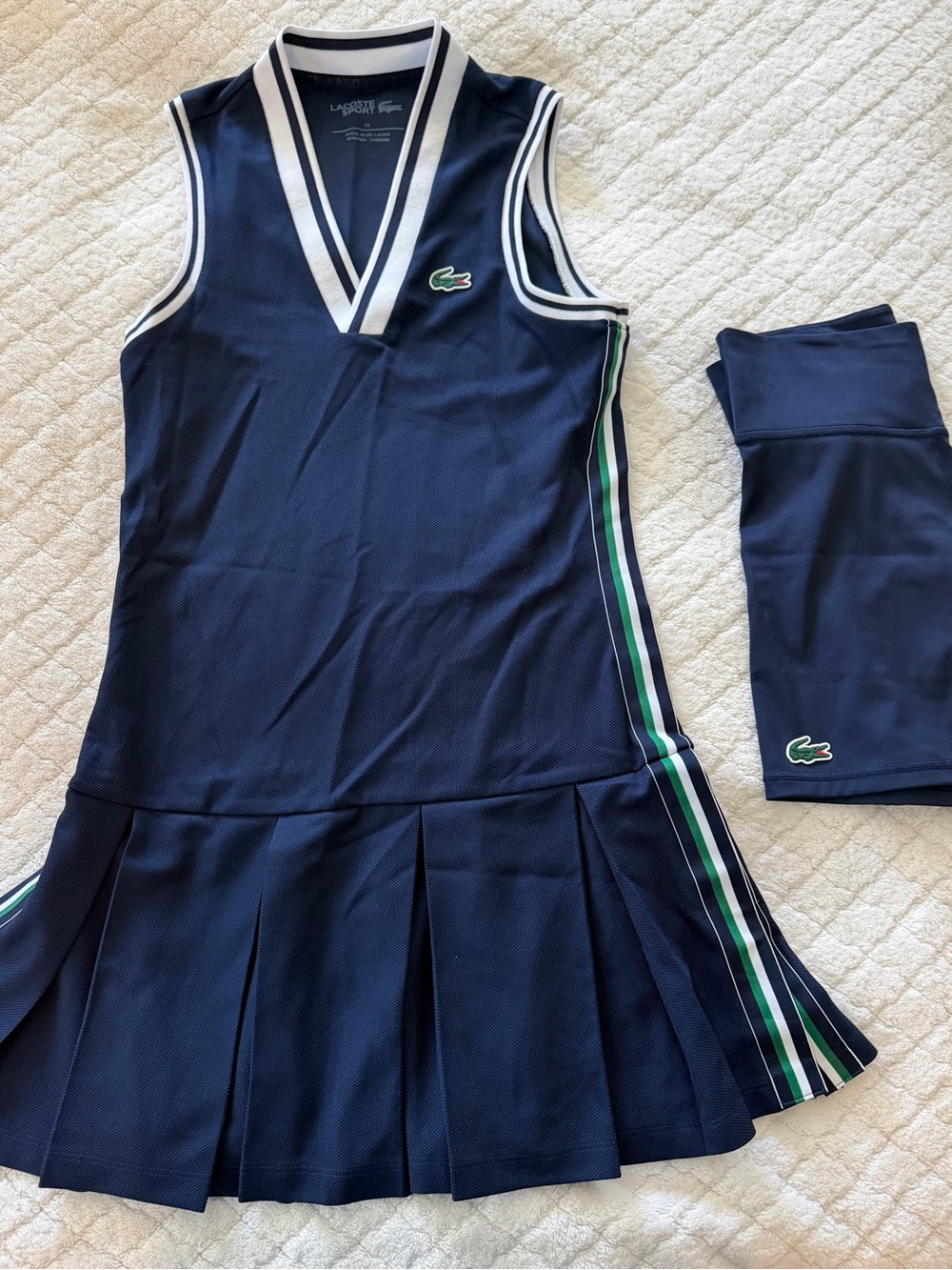 Lacoste tennis / pickleball dress in navy with green and white piping.